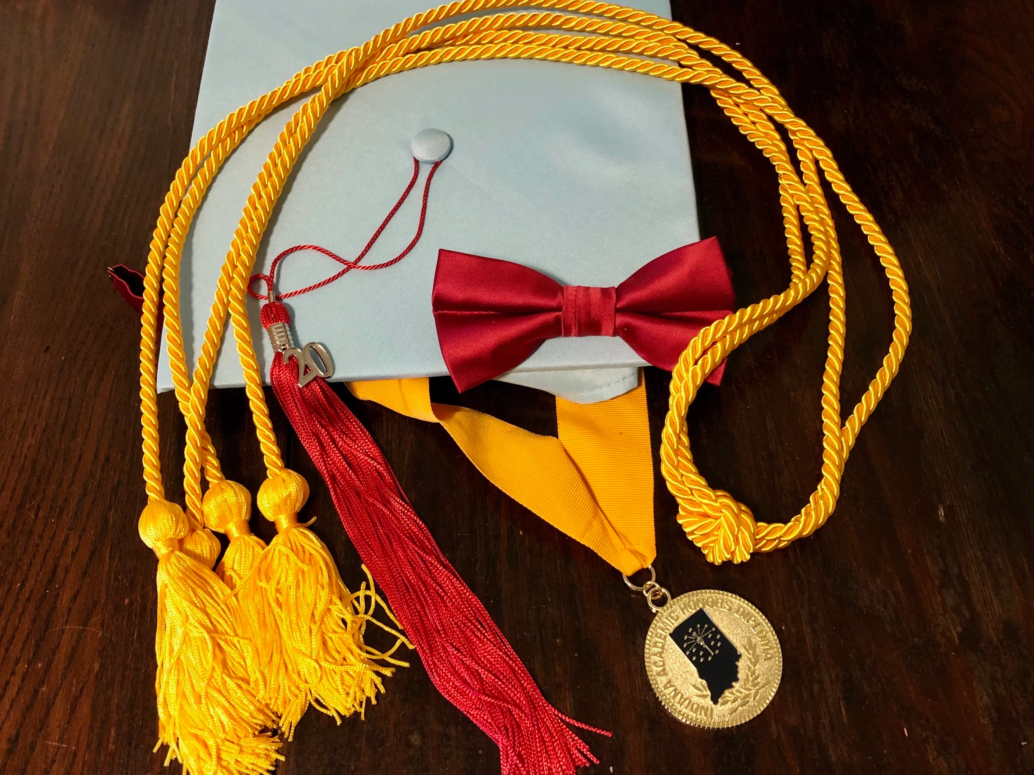 Cody's gown hat after graduating, with his medals.